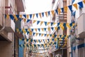 Street in Povoa de Varzim, Portugal decorated with banners and pennants to celebrate Sao Pedro festival