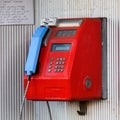 Street public telephone set in red. Street public phone close-up Royalty Free Stock Photo