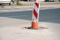 Street reconstruction or construction barricade caution red and white sign cover the open hole of manhole on the road as a precaut