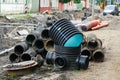 Street reconstruction view, old and new underground pipes next to a deep wide trench