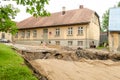 Street repair in summer day. Sand, road signs and houses