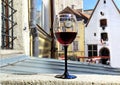 Street restaurant glass of red wine on table top street clock  urban medieval city lifestyle Tallinn old town  summer  travel to E Royalty Free Stock Photo
