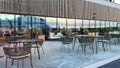 Street restaurant in new  cruise ship port of Tallinn Old town people relaxing and drink coffee reflection on modern  building win Royalty Free Stock Photo