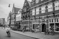 Street with restaurants, shops, cyclist and people strolling in the s-Hertogenbosch downtown. Royalty Free Stock Photo