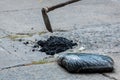 Street resurfacing. Fresh asphalt construction. Bad road. Construction site is worker laying repair asphalt road. Covering the pit