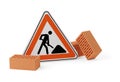 Street or road construction sign and stone bricks on white background - under construction, maintenance or attention concept