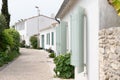 Street at Saint Martin de Re village situated on Ile de Re, France with white house and green shutter