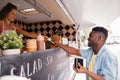 African american man buying wok at food truck Royalty Free Stock Photo