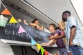 Customers or friends and saleswoman at food truck