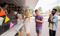 Happy customers queue at food truck