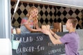 Saleswoman at food truck serving male customer