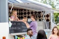 Saleswoman at food truck serving male customer