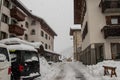 Street of Santa Caterina di Valfurva during a heavy snow storm during winter. Visible tractor removing snow