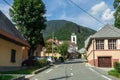 Street Scenario with buildings during main Road and main Parish Church of Village Log pod Mangartom. Bovec, Slovenia, Europe