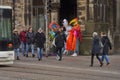 Street scene in Bremen with two stilt walkers sitting on an electric box