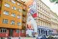 Street scene buildings of differing architecture and stunning large wall art of art deco style.