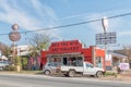 Street scene, with businesses, people and vehicles, in Parys