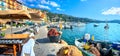 Street scene with cafe and fishing boat in resort town Villefranche-sur-Mer. Cote d`Azur, France Royalty Free Stock Photo