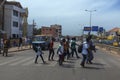 Street scene in the city of Bissau with people crossing an avenue near the Bandim Market, in Guinea-Bissau