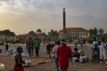 Street scene in the city of Bissau with people at the Praca dos Herois Nacionais