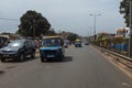 Street scene in the city of Bissau with public buses Toca Toca in an avenue near the Bandim Market, in Guinea-Bissau