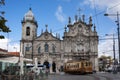 Street scene in the city of Porto with an old tram in front of the Carmelitas Church and Carmo Church, in Portugal