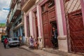 Street scene with classic old cars and traditional colorful buildings in downtown Havana. Cuba Royalty Free Stock Photo