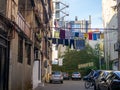 Street scene. Clothes are dried on a line. Colorful houses. Urban environment. Beautiful sunny day in the city. road traffic Royalty Free Stock Photo