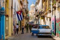 Street scene with cuban flag and classic car in Old Havana Royalty Free Stock Photo