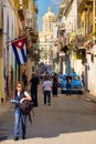 Street scene with cuban flag and classic car in Old Havana Royalty Free Stock Photo