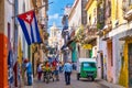 Street scene with cuban flag on a colorful street in Old Havana