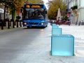 Street scene with electric bus on downtown walking alley with restaurant terraces