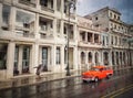 Street scene with old American car and worn out buildings in Havana, Cuba. Royalty Free Stock Photo