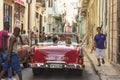 Street scene people red convertible taxi fifties Havana