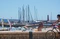 Street scene with surfer, masts and cyclist