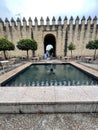 Street scene with tradiCairuan Street with pools and the walls of the Almodovar Gate in Cordoba, Spain Royalty Free Stock Photo