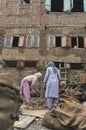 Daily street scenes from old Srinagar with hardworking people building buildings affected by violent strikes that happen of. India Royalty Free Stock Photo