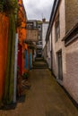 Street in a seaside town, with colorful facades of buildings, en