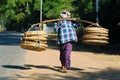 Street seller ,carrying basket in bamboo-rattan