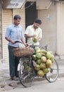 Street seller selling coconuts, India