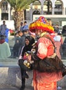 Street seller of souvenirs in bright traditional national clothes