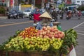 Street sellers sell fruit mango, lychee, pineapple from their bikes in traditional hats