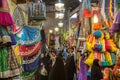 Street of the Shiraz Vakil bazar with women checking traditional colorful clothes and muslim veils. Royalty Free Stock Photo