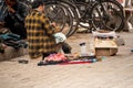 street side cobbler sitting on road and mending shoes in the winter months in sector 17 chandigarh during morning