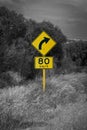 Street sign in Australia warning right curve ahead speed 80 in black and white with yellow accent Royalty Free Stock Photo