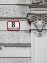 Street sign with architectural elements of Number 8 of Goldsmith Alley. Austria. Vienna