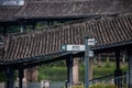 Street sign next to a bridge in the beautiful Dongpo Urban Wetland Park, Meishan