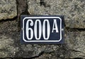 Street sign number 600 on a stone wall Royalty Free Stock Photo