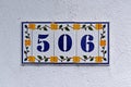 Street sign number 506 on a white wall