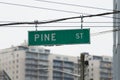 Street sign for Pine Street in Seattle hanging from wires